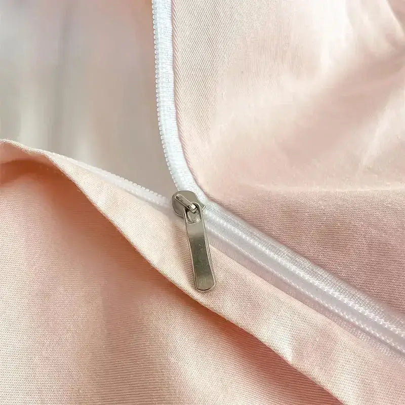 Luxury white silver embroidered cotton bedding set featuring a delicate pink satin zipper with a sleek silver pull tab