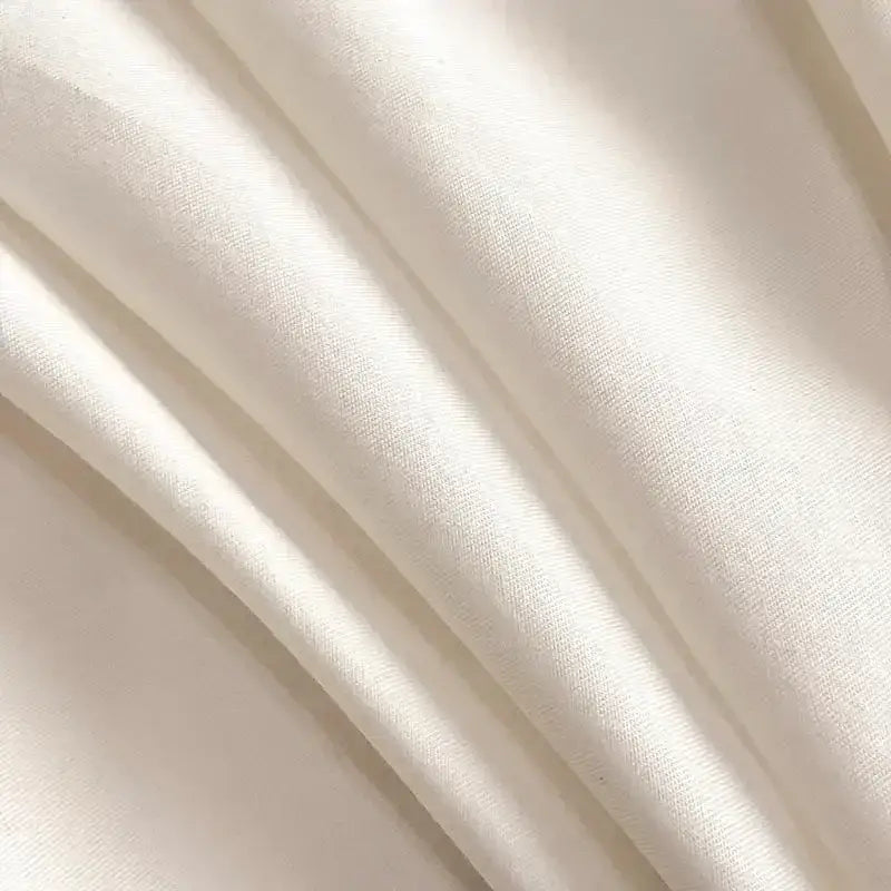 Soft off-white silk fabric with a smooth gloss texture showcasing decorbites embroidered cotton bedding set quality