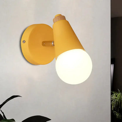 Yellow macaron loft sweet cone wall sconce with a matte metal finish and wood accent for corridor lighting