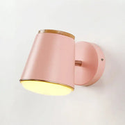 Macaron pink and gold fabric wall lamp featuring a cylindrical wall light with wooden accents for bedroom decor