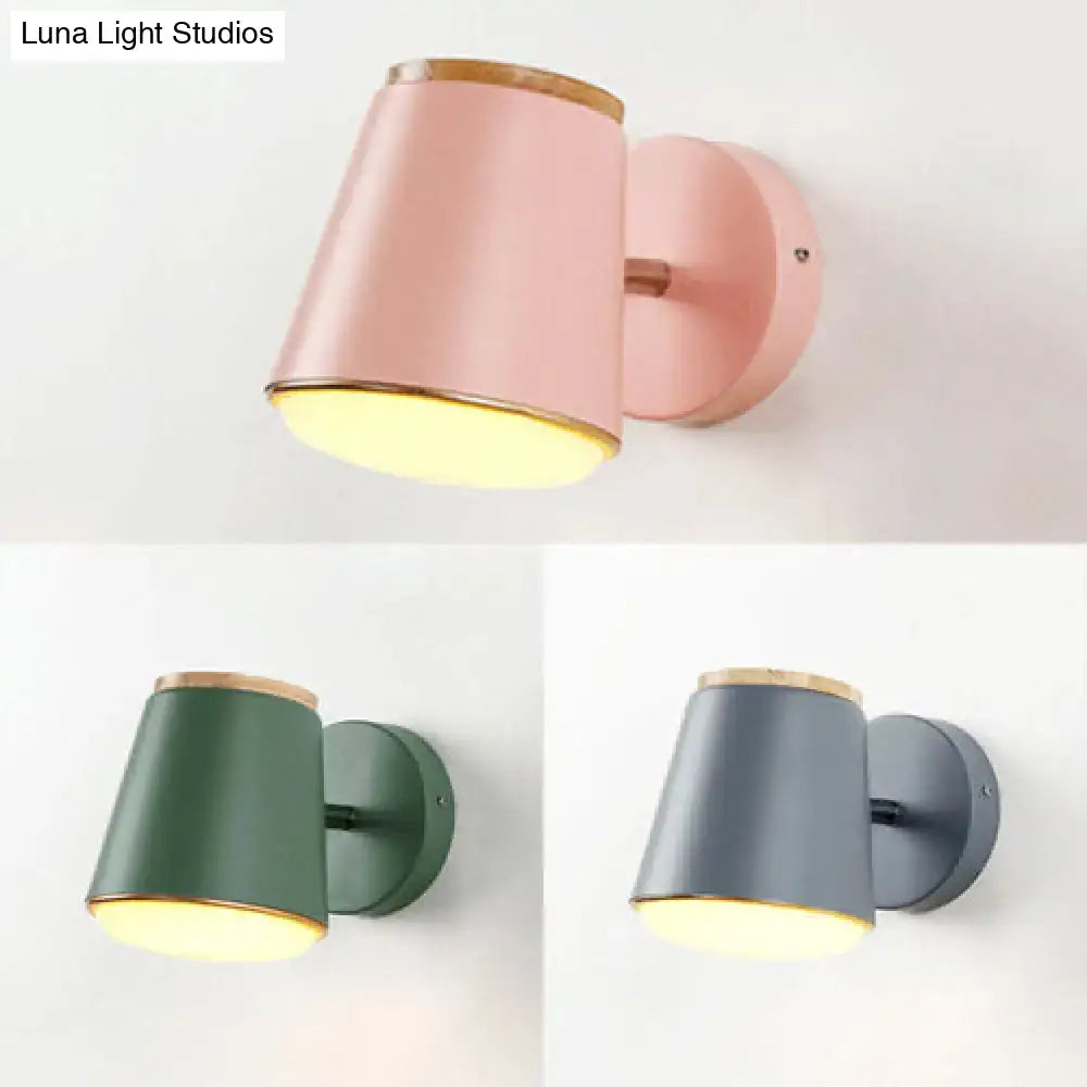Macaron pink and gold fabric wall lamp with matte finish wooden rim and warm yellow light cylindrical sconce wall light