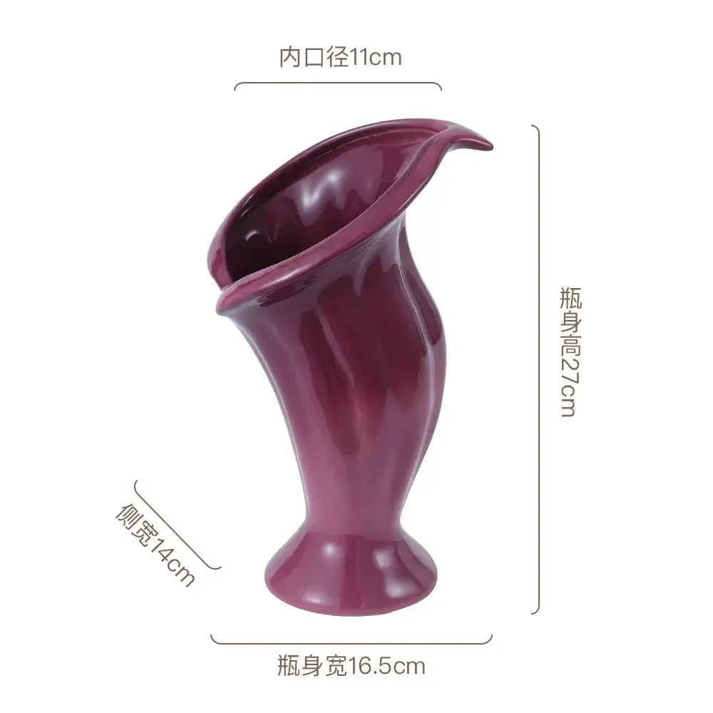A glossy deep purple ceramic vase shaped like a calla lily with smooth contours for decorbites calla lily decor