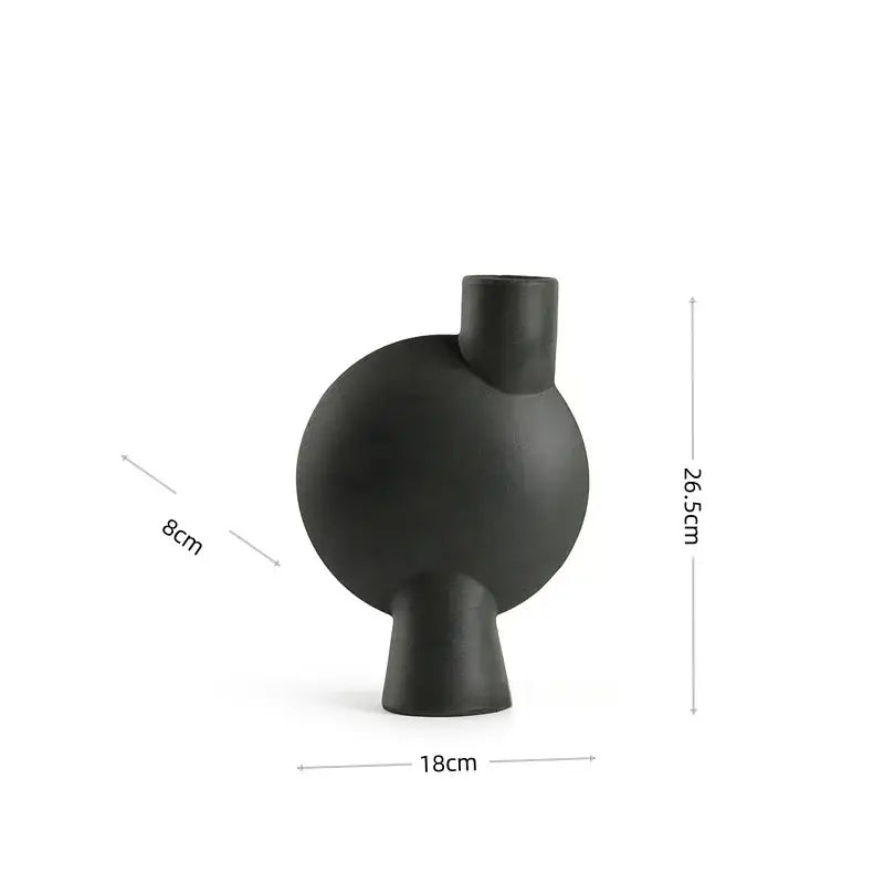 Matte black ceramic vase with rounded body short stem and cylindrical neck decorbites calla lily living room decor