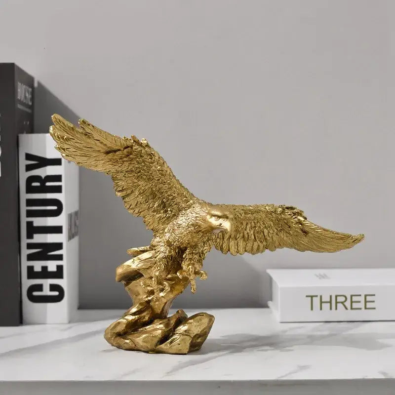 Majestic gold resin eagle sculpture with metallic finish and detailed feather texture perched on rocky base for decor
