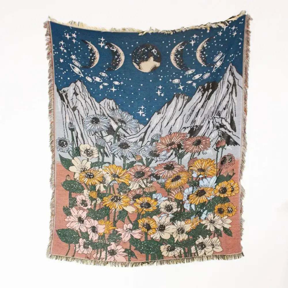 A mandala black geo tassel picnic mat and sofa cover with woven celestial moons stars and sunflower field design