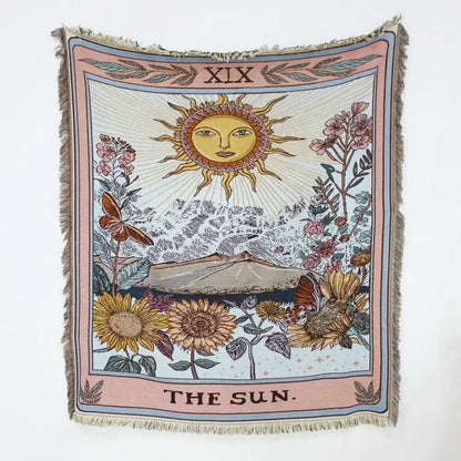 A soft woven mandala black geo tassel picnic mat and sofa cover featuring a vintage sun tarot card design on pastel pink