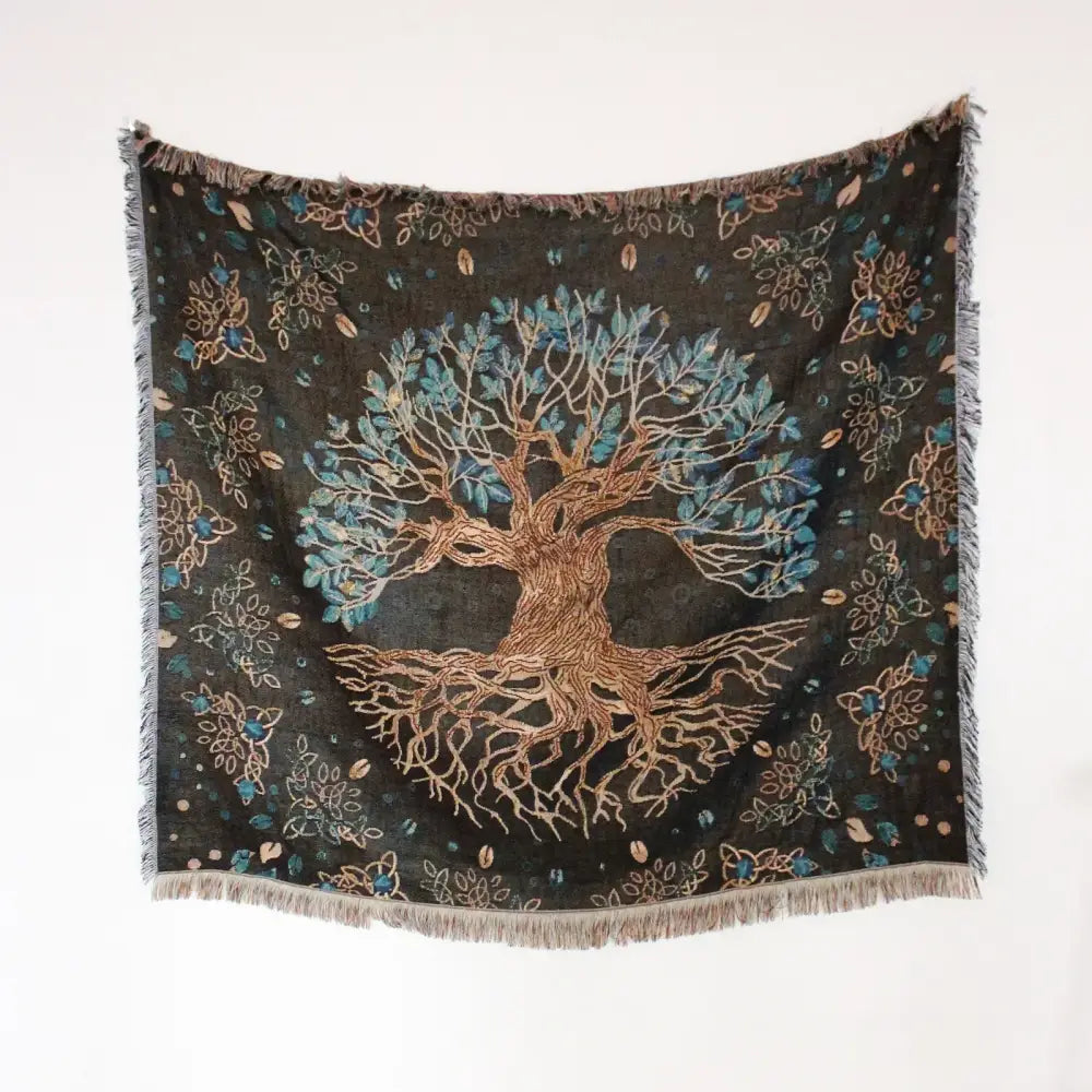 A dark green mandala black geo tassel picnic mat and sofa cover with tree of life design and intricate floral patterns