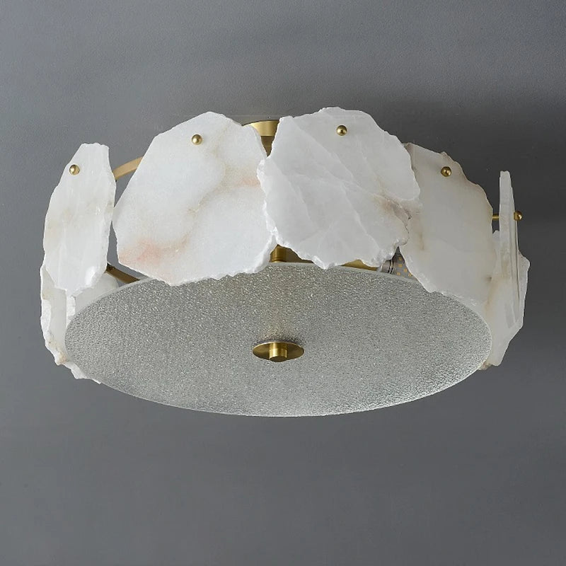 White translucent alabaster stone slices with veining arranged around frosted glass diffuser on marble led chandelier round pendant light