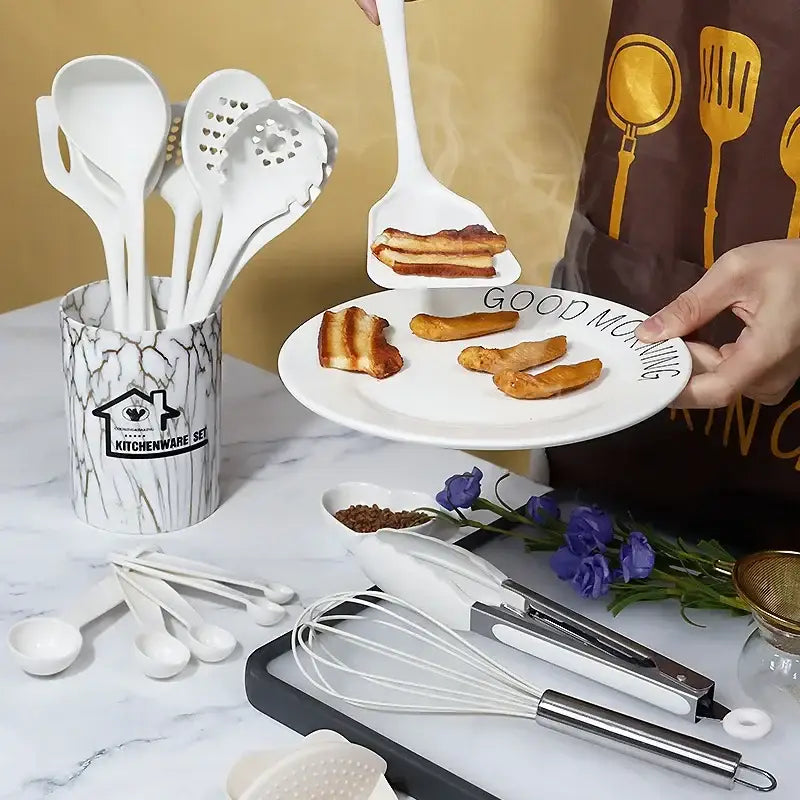 White silicone spatula with flat head lifting bacon from plate in marble pink silicone cooking tool set with container