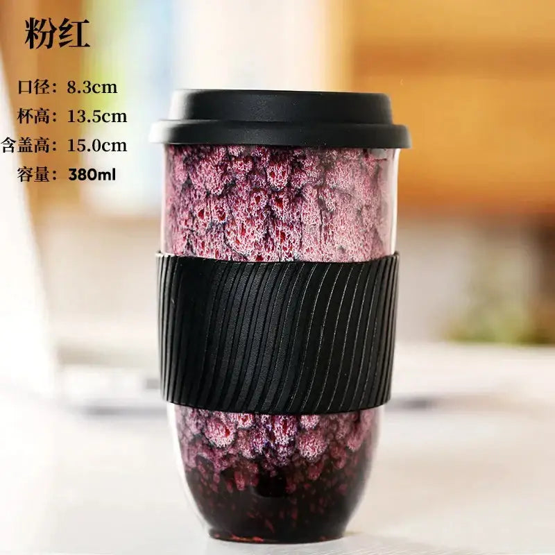 Pinkish-red decorbites ceramic kiln mug with black lid and textured silicone grip for kitchen travel use