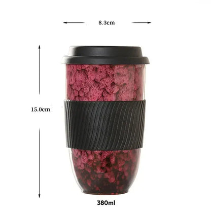A 380ml decorbites ceramic kiln mug with a pink and black speckled exterior and silicone grip for travel use