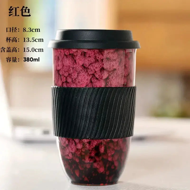 Red speckled decorbites ceramic kiln mug with black lid and silicone grip band for kitchen travel use