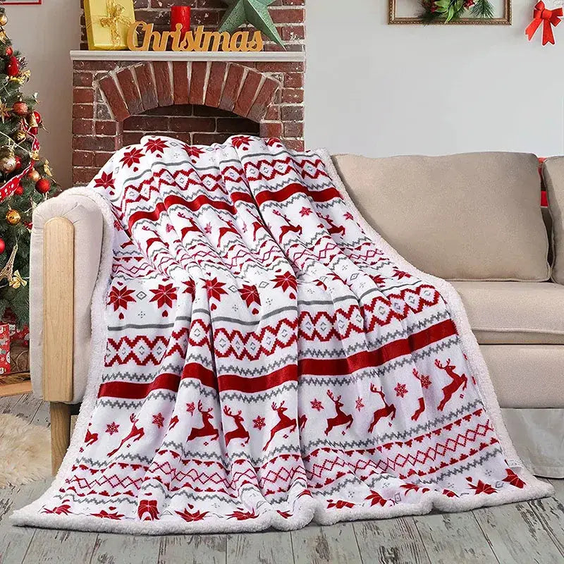 A cozy flannel blanket in white red and gray with reindeer and snowflake patterns for living room sofa by decorbites cozy