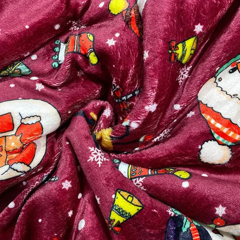A maroon decorbites cozy flannel blanket with festive santa hats and snowflakes for living room sofa use