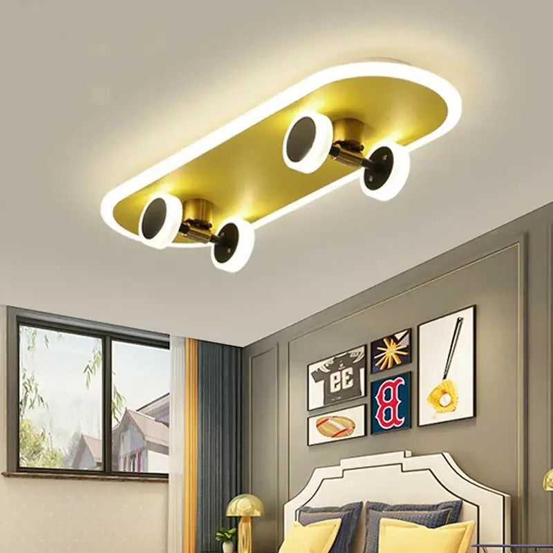 Gold-colored decorbites cartoon skateboard ceiling light with white led strip lighting and black wheels for children room
