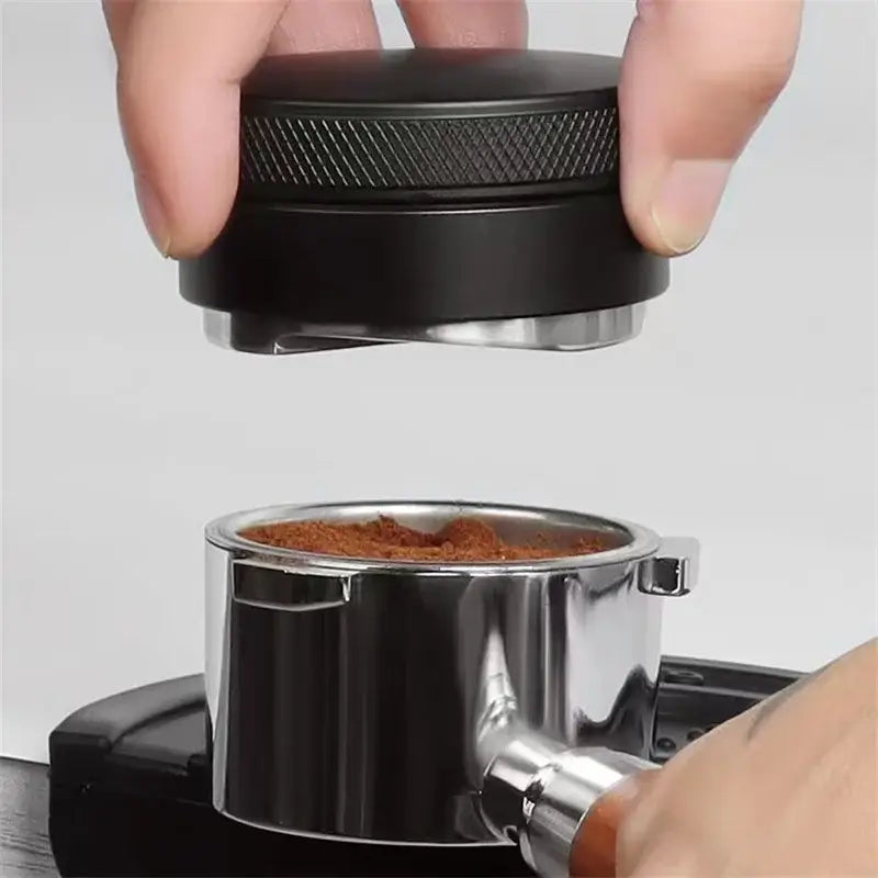 Matte black adjustable palm tamper with textured handle and metallic base for precise coffee distribution