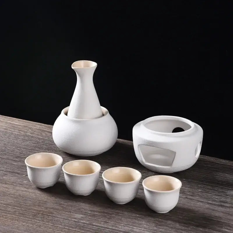 White ceramic sake set with slender-necked decanter four cups and insulated warmer from decorbites ceramic sake kit