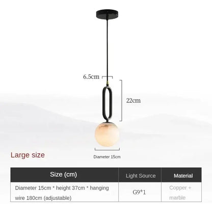 Matte black and polished copper marble pendant light with spherical amber glass shade for dining room use