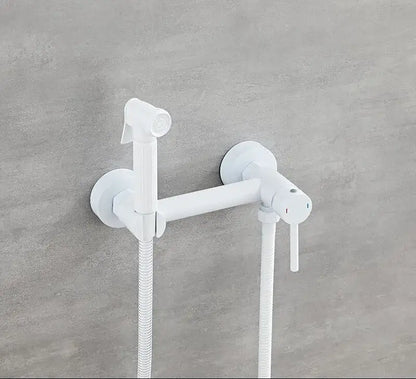 Matte black bidet faucet set with handheld sprayer and flexible hose mounted on a white wall for bathroom use