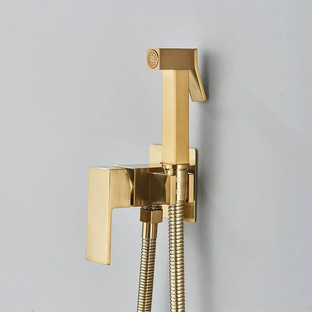 Gold-colored brass bidet faucet with sleek rectangular design and flexible hose for modern bathroom decorbites brass bidet