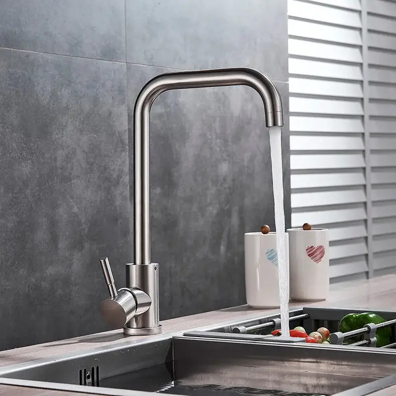 Matte black and brushed nickel decorbites kitchen faucet with a sleek curved spout and minimalist stainless steel design