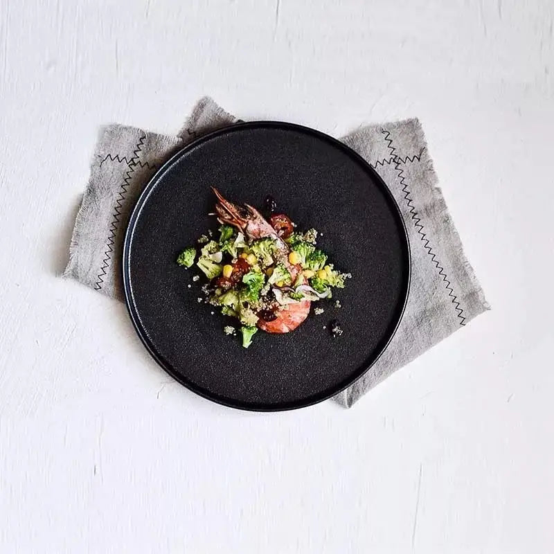 Matte black ceramic dinner plate by decorbites featuring a black ceramic dinner design with shrimp and vegetables dish
