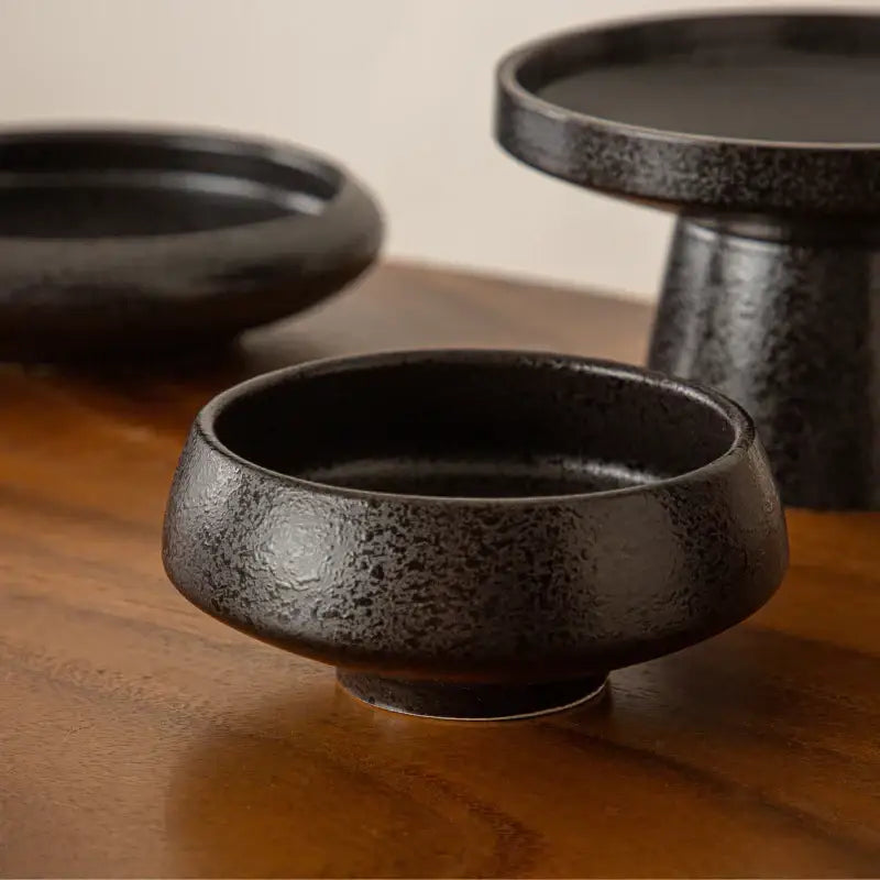 Matte black ceramic vase sword mountain set featuring a speckled decorbites ceramic vase with rounded edges