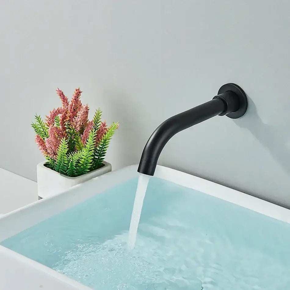 Matte black dual handle bathtub faucet set with sleek curved spout flowing water into white sink decorbites faucet set