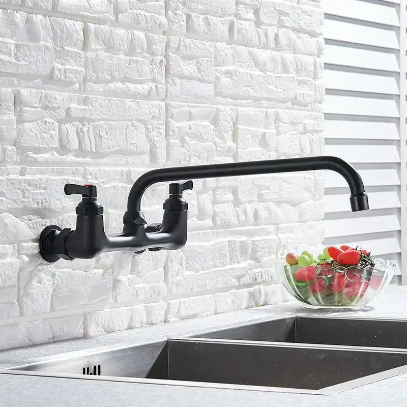 Matte black dual handle kitchen faucet with swivel hot cold water tap mounted above stainless steel sink