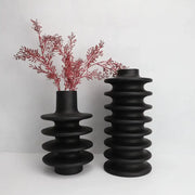 Two matte black ceramic vases with geometric circle spiral ridges and narrow neck for living room decor