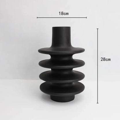 Matte black geometric circle spiral ceramic vase with tiered stacked rings and cylindrical neck for living room decor