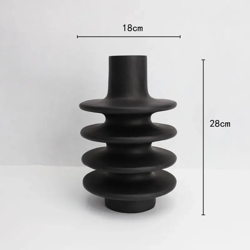 Matte black geometric circle spiral ceramic vase with tiered stacked rings and cylindrical neck for living room decor