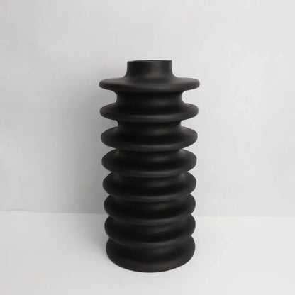 Matte black ceramic vase with geometric circle spiral ribbed rings creating a textured segmented design for living room decor