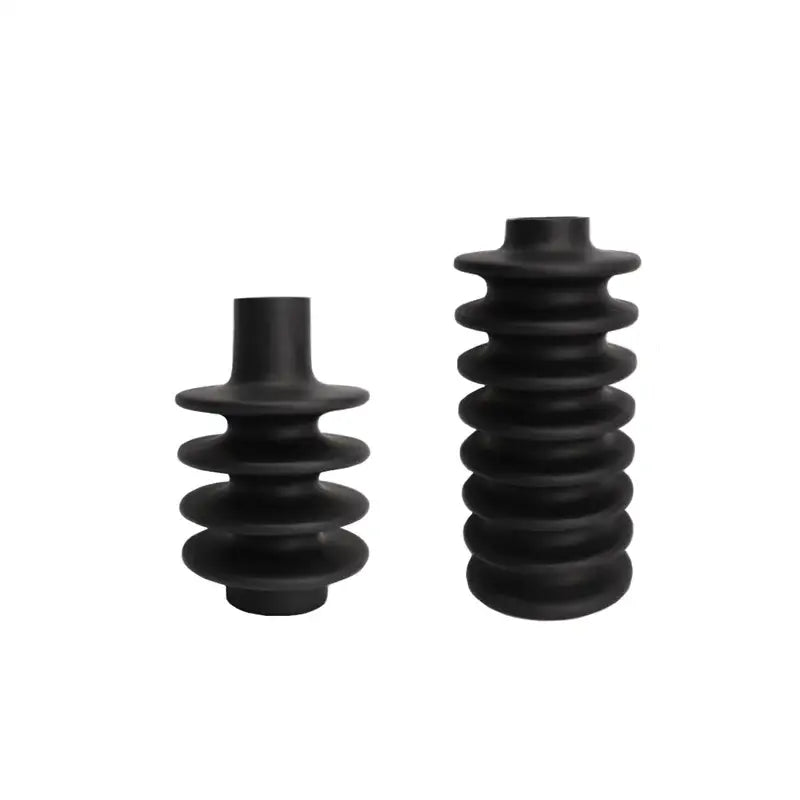Matte black rubber insulators with a ribbed segmented design complement geometric circle spiral ceramic vases for decor