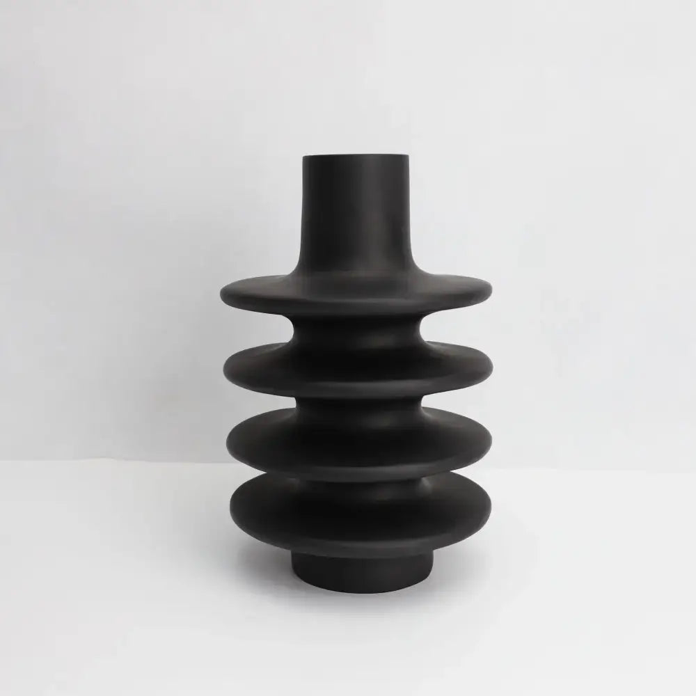 Matte black ceramic vase with stacked tiered rings and geometric circle spiral design for living room decor
