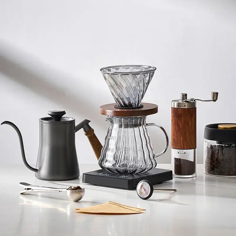 Clear glass pour-over coffee maker with ribbed cone and base paired with matte black gooseneck spout kettle hand punch coffee pot