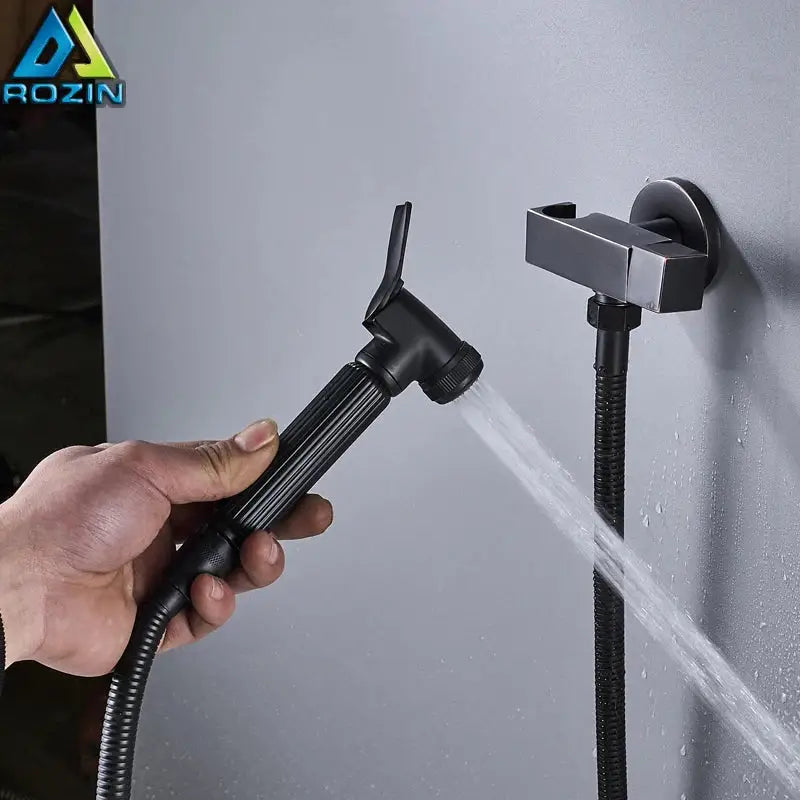 Matte black handheld bidet faucet with ribbed grip and flexible hose mounted on wall for bathroom use decorbites black bidet