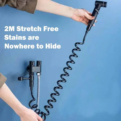 Matte black hygienic bidet sprayer with flexible coiled hose and matching handheld spray head for bathroom use by decorbites