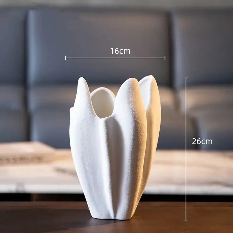 A sleek white ceramic vase with irregular pleated petal design and matte finish for modern decorbites irregular pleated decor