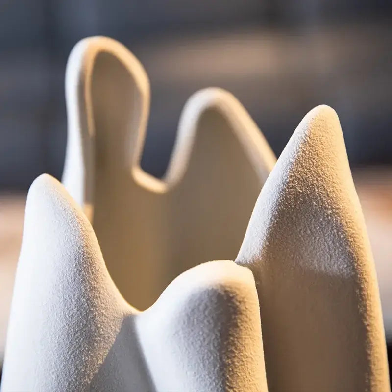 Cream-colored ceramic crown with textured matte finish and sculpted peaks in decorbites irregular pleated ceramic vase set
