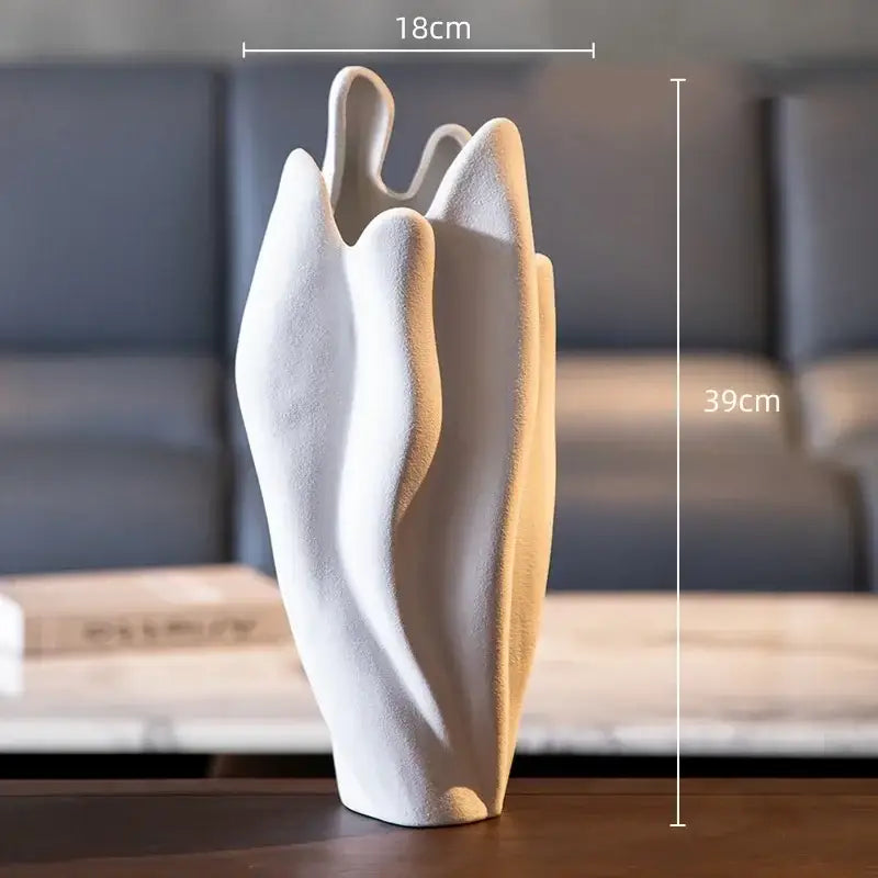 A sleek white irregular pleated ceramic vase with modern abstract leaf design for decorbites living room decor