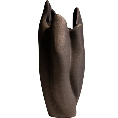 A sleek dark bronze sculptural irregular pleated ceramic vase with smooth curves for living room decorbites decor
