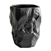 A matte black ceramic mouthwash cup with rugged texture and irregular contours for silicone mold decorbites