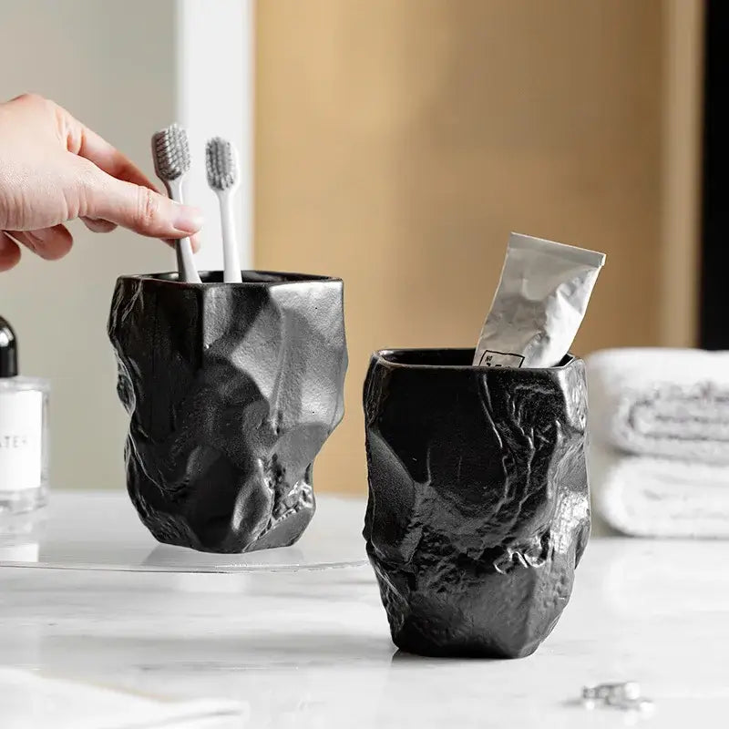 Matte black ceramic mouthwash cup with rugged faceted texture made from silicone mold decorbites irregular shaped design
