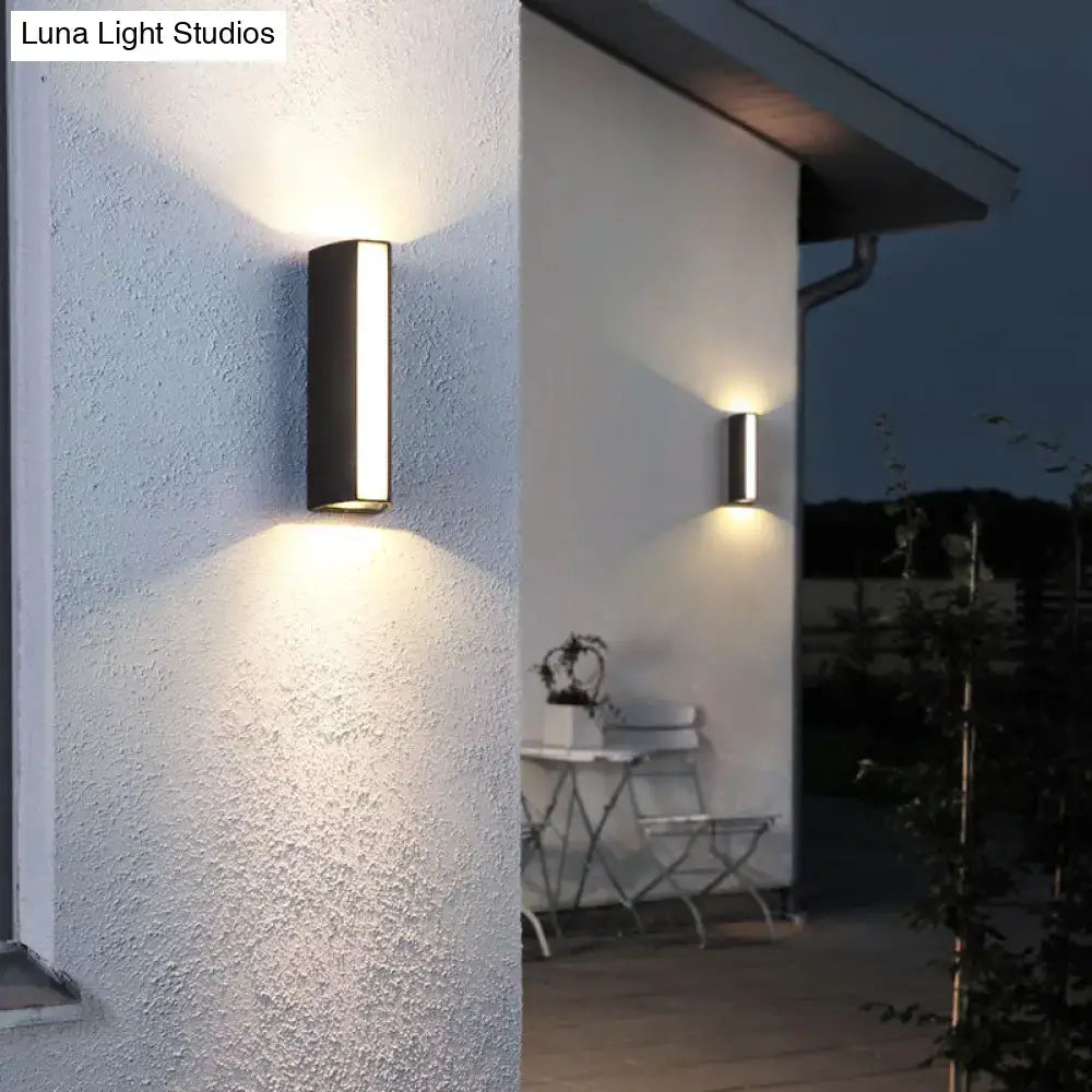 Matte black rectangle outdoor wall light with sleek minimalist design and warm dual directional led ambient light