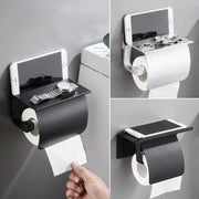 Matte black and silver toilet paper holder with wall-mounted phone shelf and matte finish for bathroom storage