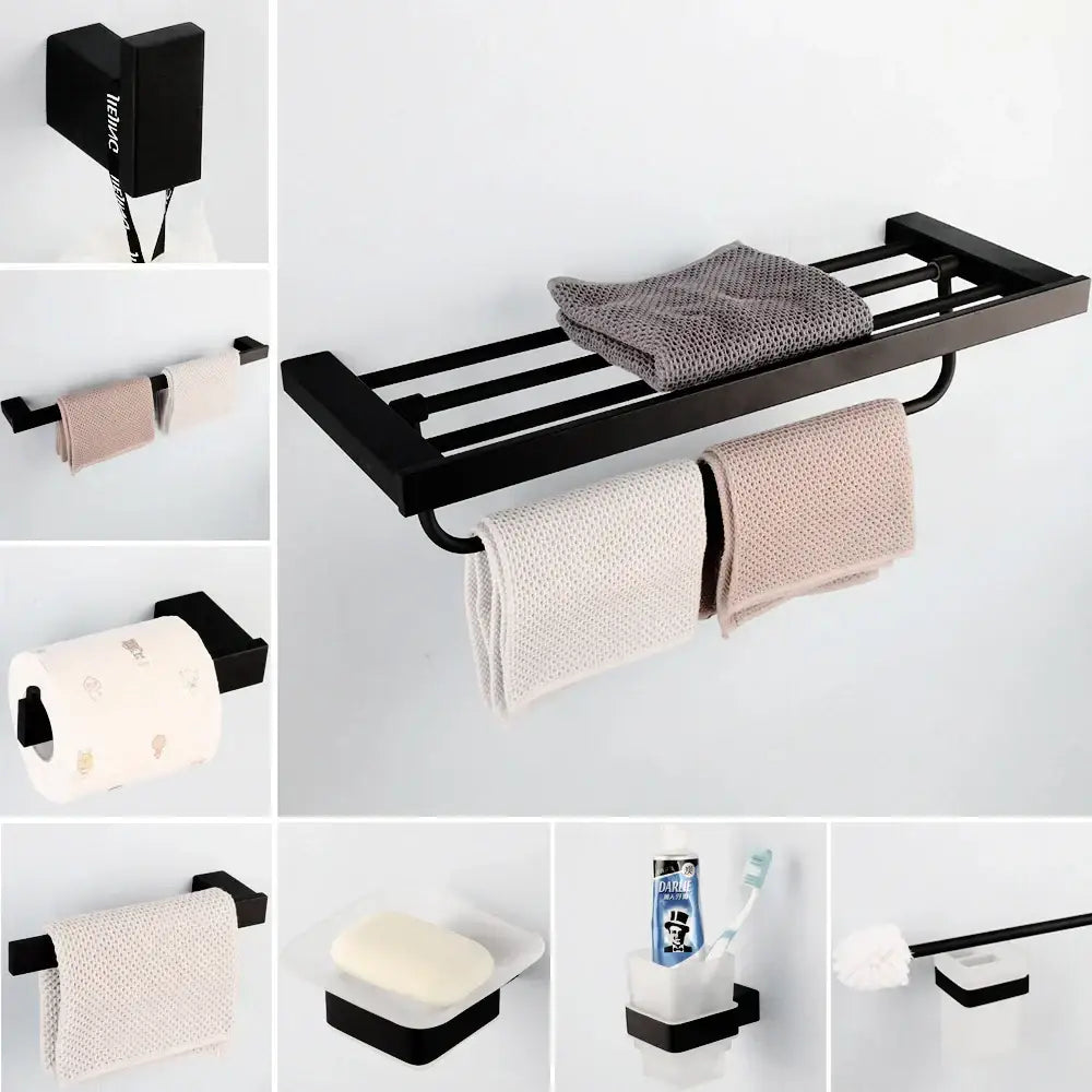 Matte black stainless steel bathroom hardware set with multiple towel bars and a frosted glass shelf for towels