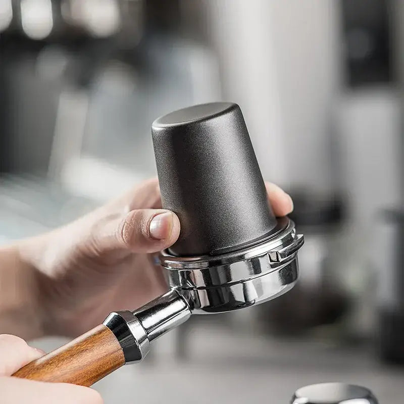 Matte black and stainless steel espresso dosing cup with black matte coffee tamper and wooden handle by decorbites espresso dosing