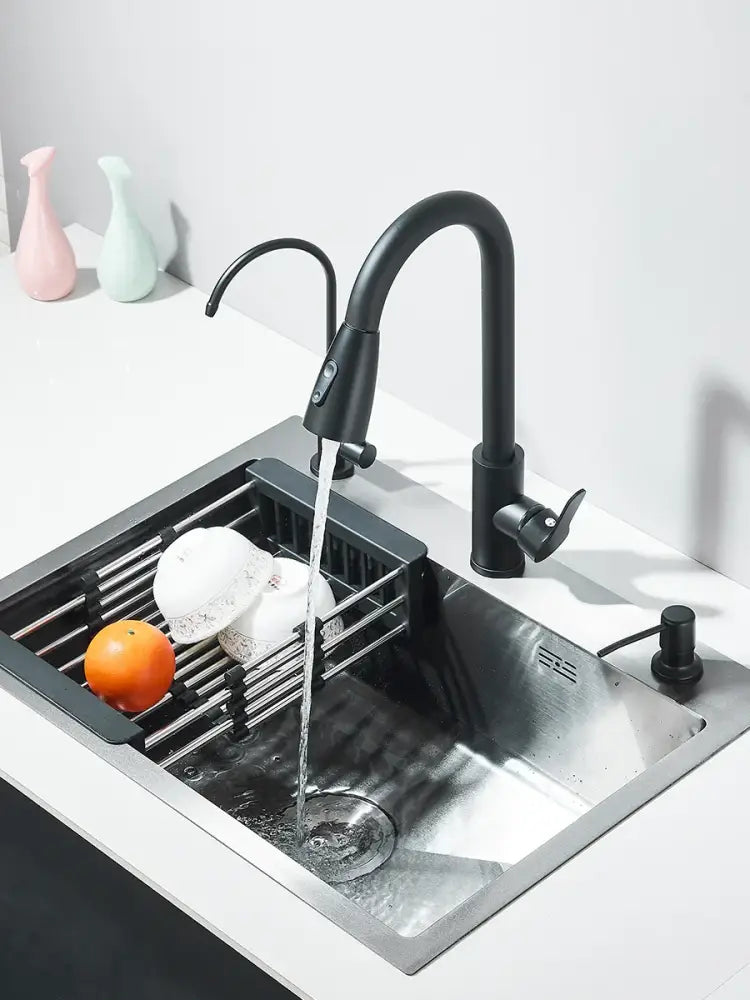 Matte black stainless steel kitchen sink with retractable black matte faucet and integrated soap dispenser