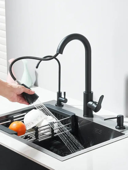Matte black stainless steel kitchen sink with retractable faucet featuring a flexible pull-out spray head and arched spout